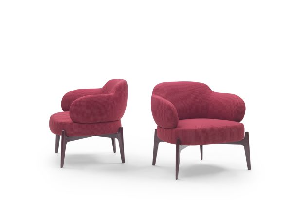 Elevate your interior with our designer armchair on artful legs, a true statement of contemporary living.