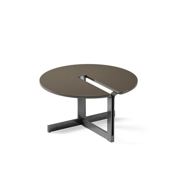 The Cut-Out Coffee Table features a unique and modern design with a round top and a metal base