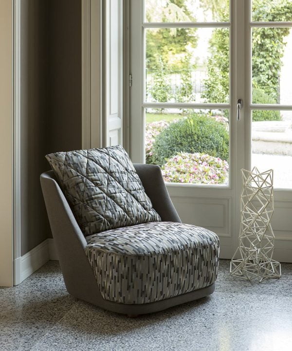 This modern armchair features a sleek metal frame that adds a touch of industrial chic to any room