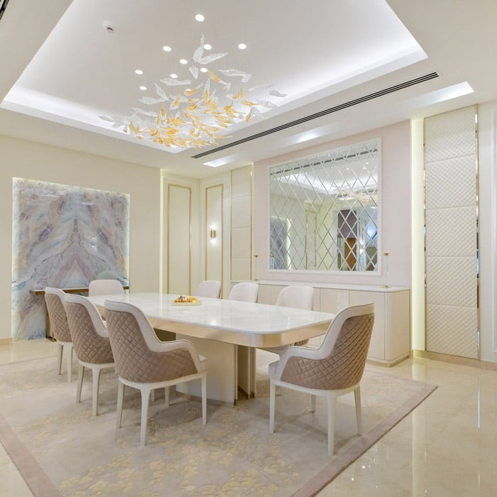 Luxury majlis dining room interior design with a marble top table and leather chairs