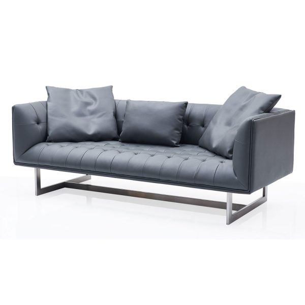 low-back capitone sofa on sleek metal legs adds a touch of modern flair to any room.