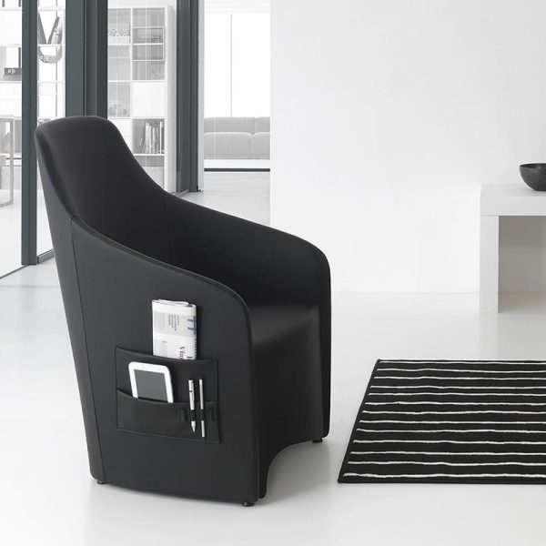 A modern black armchair in a white room